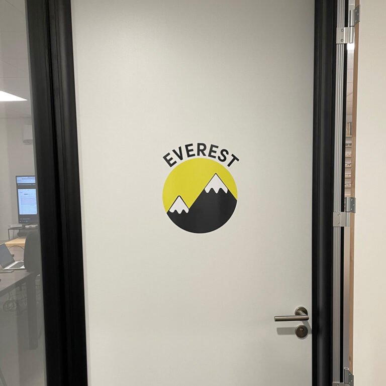 Logo Everest visible sur une porte vitrée.